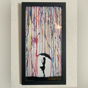 Framed picture of girl holding umbrella with multi color rain paint. 14x26